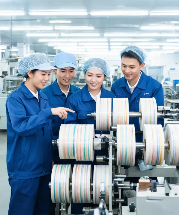 IPG plant team reviewing slit tape rolls